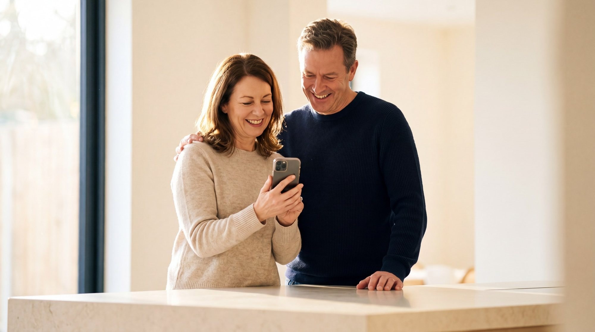 Couple looking at information together on a phone at home